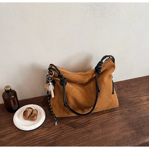 Sac hobo en daim marron avec bandoulière à nœuds noirs et breloques de sport