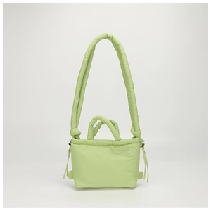 Detail view of light green quilted nylon drawstring bag with dual strap textures