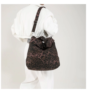 Detailed back view of a large leopard print canvas tote bag with adjustable shoulder strap