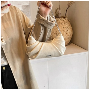 Detail view of cream pleated PU leather shoulder bag with silver chunky chain strap