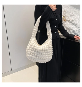 Close-up of white quilted puffer shoulder bag with soft textured hobo design for women