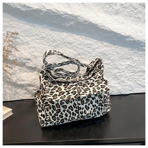 Fashionable leopard print canvas tote bag with multiple pockets and wide shoulder strap