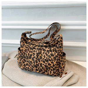 Fashionable leopard print canvas crossbody bag with multi-pocket design and wide strap