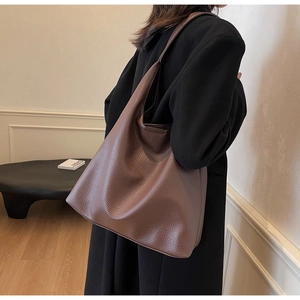 Detailed macro view showing the rich lychee texture on this large brown PU leather tote bag