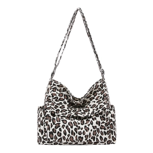 Large leopard print canvas shoulder bag with front flap pockets and adjustable strap