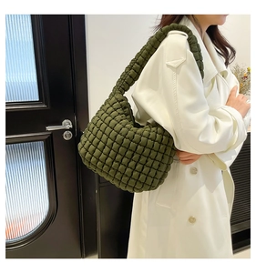 Close-up of olive green quilted bubble shoulder bag with a unique textured puffy design