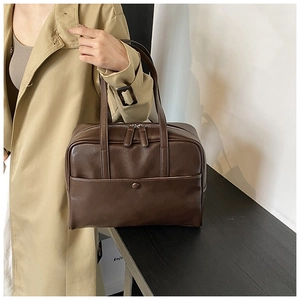 Detailed view of a vintage brown PU leather Boston bag with double zipper and front pocket