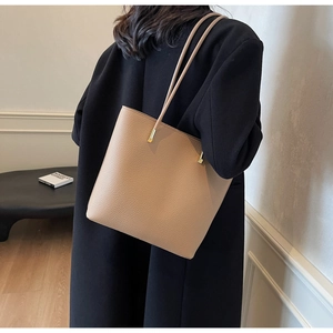 Detail view of beige PU leather shoulder bag featuring elegant gold hardware on strap