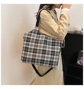 Detail of checkered canvas tote bag with adjustable black strap for women