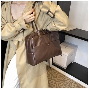 Detail view of premium brown PU leather handbag featuring smooth texture and elegant stitching