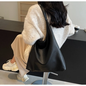 Detailed close-up of the black pebble grain leather texture on this large hobo shoulder bag