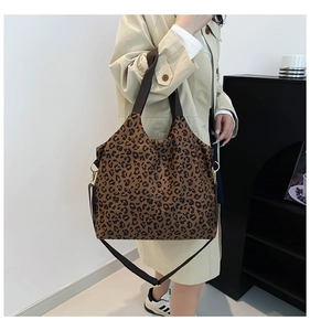 Detail view of the leopard print tote bag fabric with adjustable woven shoulder strap