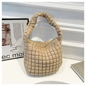 Minimalist beige quilted cloud shoulder bag with textured bubble pattern and sleek design