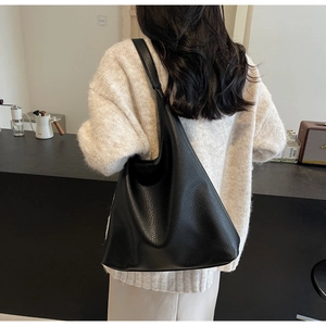 Black lychee texture PU leather tote bag shown in a stylish over-the-shoulder view