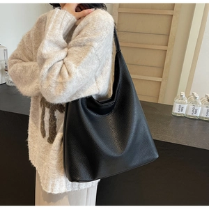 Litchi texture black PU leather tote bag shown on a model for a stylish daily outfit look