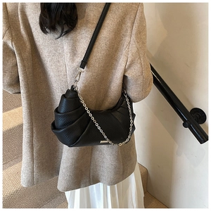 Detailed view of black pebbled PU leather pleated crescent bag with silver chain strap