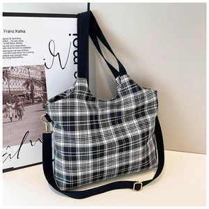 Chic black and white plaid canvas tote bag with adjustable shoulder strap and gold hardware
