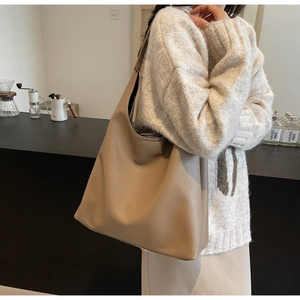 Minimalist apricot pebbled PU leather tote bag with wide integrated shoulder strap detail