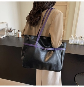 Detail showing high-gloss black PU tote bag with contrasting purple straps and silver buckles