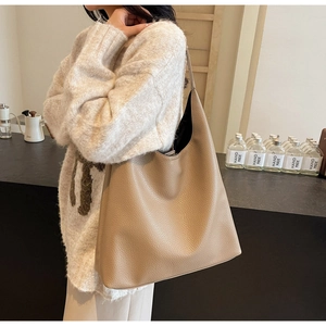 Close-up of litchi grain PU leather hobo shoulder bag with minimalist soft texture design
