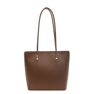 Minimalist brown pebbled leather tote bag with elegant gold hardware and slim shoulder straps