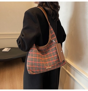 Detail showing vintage houndstooth shoulder bag with leather strap and mini pouch