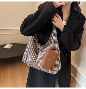 Detail of autumn houndstooth tote bag with a small brown leather detachable pouch