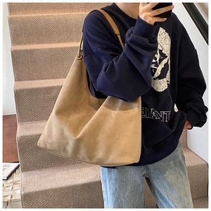 Gros plan détaillé du grand sac hobo en daim camel avec anneau métallique minimaliste