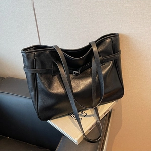 Minimalist black PU leather tote bag with lychee texture and decorative buckles for women