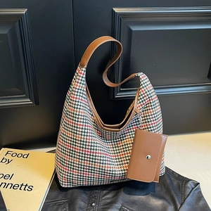 Chic autumn hobo bag in multi-color houndstooth fabric with a brown leather shoulder strap