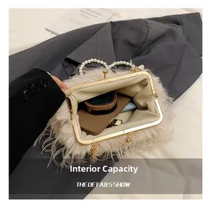 Detail view of plush shoulder bag interior capacity with pearl handle and metal lock