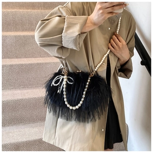 Detail of black faux feather bag with pearl chain and beaded bow tassel charm