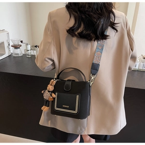 Chic black PU leather handbag with gold trim pocket and colorful vintage patterned strap