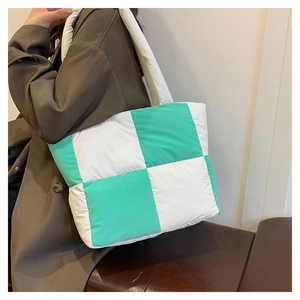 Detail of green and white checkered puffer tote bag in quilted nylon material