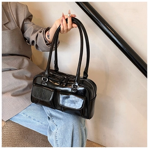 Detail showing high-gloss black PU leather shoulder bag with silver hardware and pockets