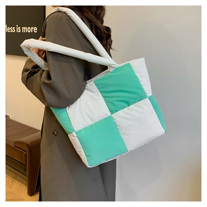 Detailed shot of quilted checkerboard tote bag with soft mint and white nylon fabric