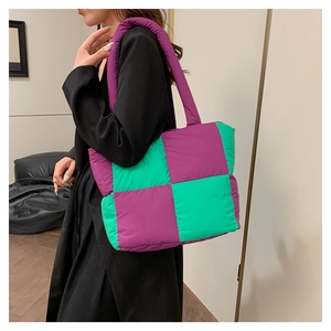 Close-up of quilted puff tote bag in purple and green checkerboard pattern fabric