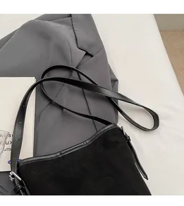 Detail view of the black PU leather shoulder bag featuring matte texture and metal buckle