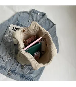 Interior view showing large capacity of quilted tote bag with tablet and umbrella