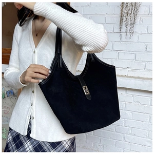Close-up of matte black hobo bag featuring premium suede texture and metal buckle detail