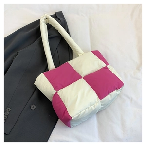 Macro detail of pink and white checkered quilted nylon fabric on a large tote bag