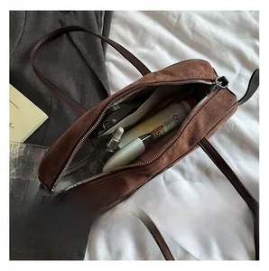 Vue intérieure du sac à bandoulière en PU marron montrant sa capacité et sa doublure