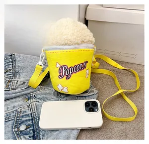 Detailed view of yellow popcorn-shaped crossbody bag with white fuzzy top and size reference