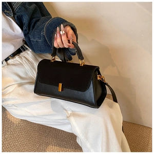Detail of black PU matte texture shoulder bag with golden square metal buckle on cover