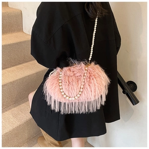Detailed view of a pink fluffy feather handbag featuring a white pearl crossbody strap