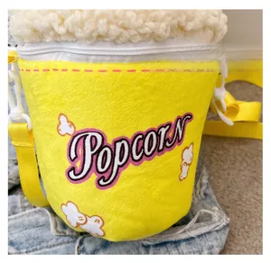 Detail view of yellow popcorn plush crossbody bag with zipper and cartoon texture