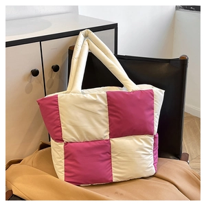 Detail of quilted puffer tote bag featuring pink and cream checkerboard pattern texture