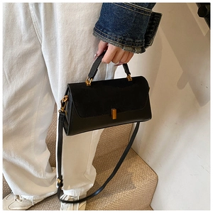 Detail of a black square PU crossbody bag with suede拼接 flap and gold metal buckle closure