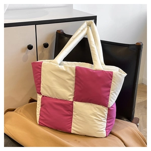 Detail shot of the quilted pink and white checkered nylon tote bag on a chair
