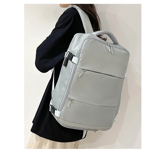 Detail of light grey business backpack featuring reinforced handle and side buckles